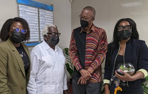 Kadine Reynolds with colleagues at the JN directory board